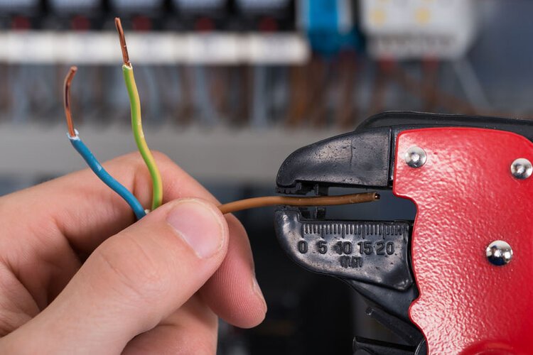 Electrician Hands Stripping Electrical Wires